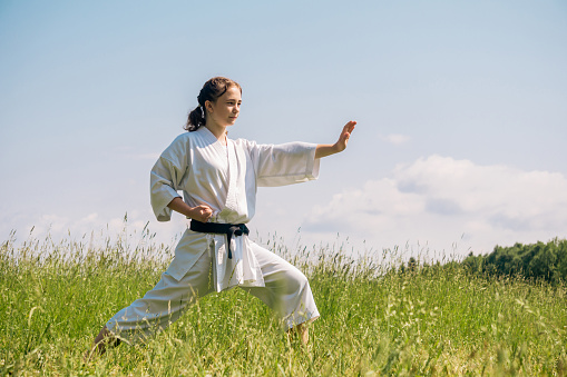 teen girl practicing karate kata outdoors