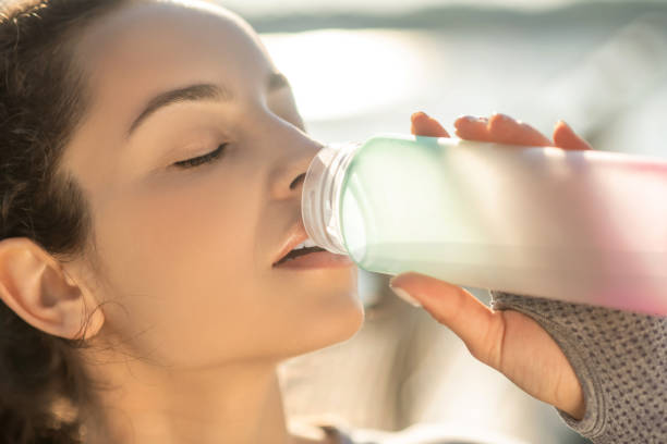 istock Young girl drinking water after the workout 1326950415
