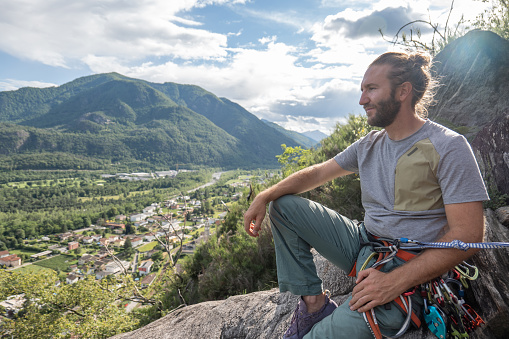 People outdoor activities. River below, mountain range in distance.\nTicino canton, Switzerland
