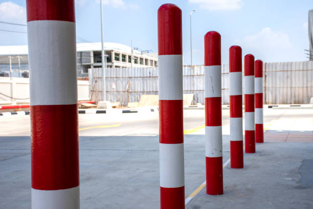 Row of red and white traffic barrier pole on car parking lot. Row of red and white traffic barrier pole on car parking lot. barricade stock pictures, royalty-free photos & images