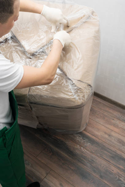 istock delivery worker opens a box with a delivered cargo with a knife, top view 1326957674
