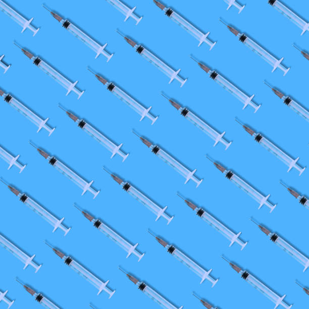 istock The syringes lay down on the blue background, pattern square flat lay composition, minimal imunization concept 1326958715