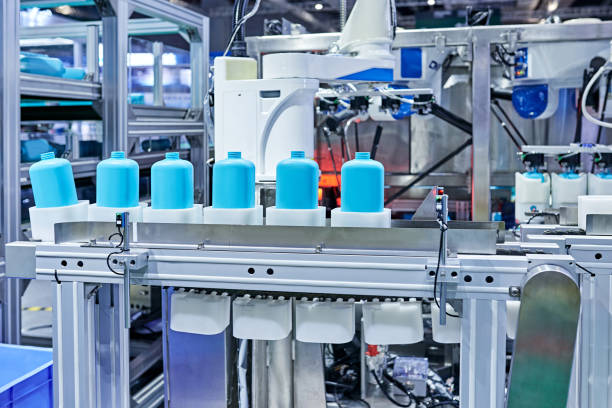 istock Robot Arm Gripping Bottles at Production Line 1326958886