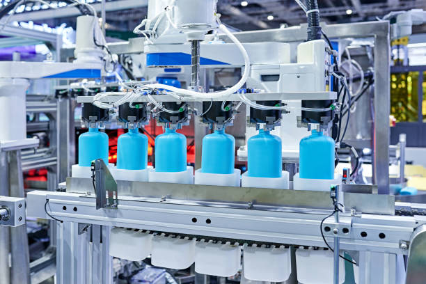 istock Robot Arm Gripping Bottles at Production Line 1326958939