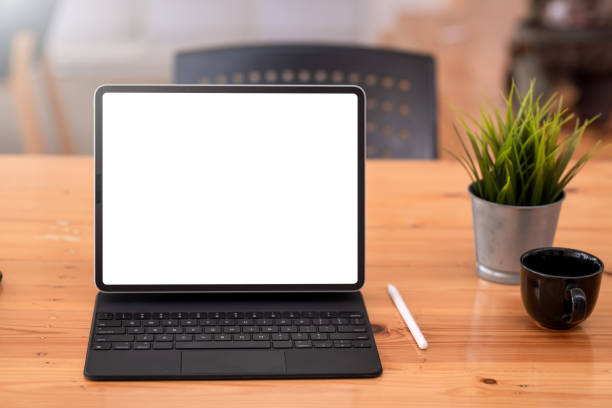 istock Front view. Digital tablet blank white screen is placed at the desk at the office. Mock up. 1326960508