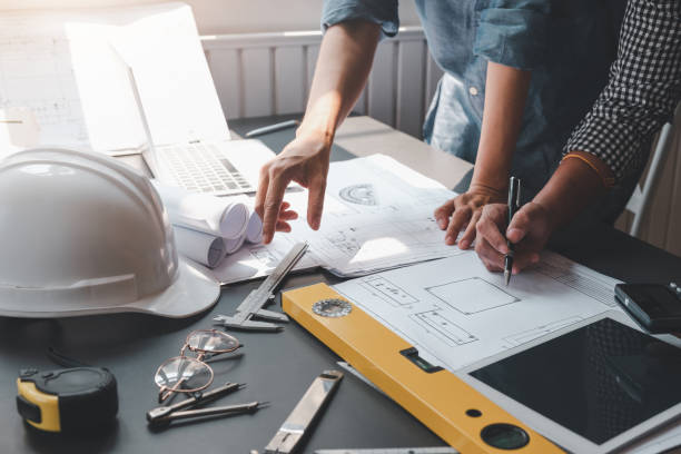 istock Architect man meeting planning collaboration using blueprints at the office. 1326961087