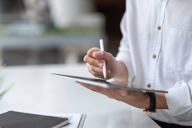 istock Young man working with a tablet in a modern office. 1326961144