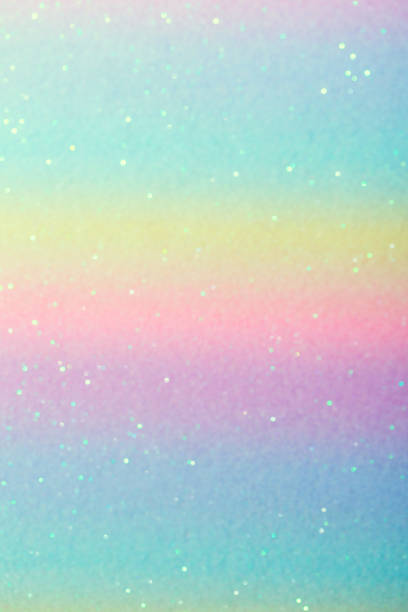 istock Iridescent paper surface with glitter. Abstract blurred multi-colored pastel background with sequins 1326961287