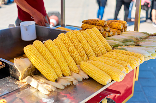Street counter selling grilled corn in Istanbul. Street food in Turkey.