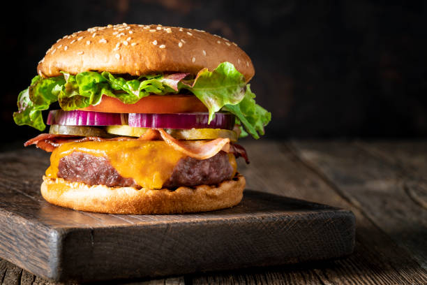 istock Cheeseburger Burger Patty classic on rustic board of wood 1326962605