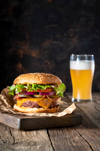 istock Cheeseburger Burger Patty classic with beer menu on rustic board of wood 1326962612