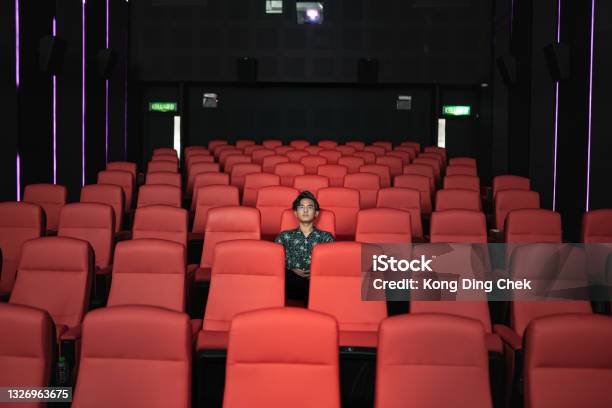 Asian Chinese Teenager Alone In Cinema Watching Movie Stock Photo - Download Image Now