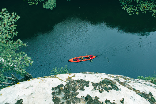 Engelberg, Switzerland - 8 August 2020: tourists rowing in their boat at lake Truebsee above Engelberg on the Swiss Alps