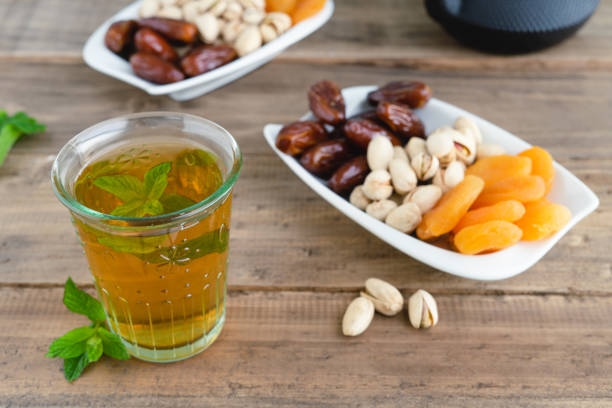 istock Dried fruit tray with tea glass on wooden background. Copy space. 1326964978