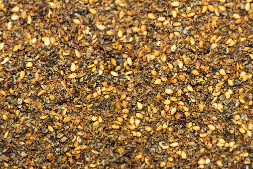 Raw Organic MIddle Eastern Zaatar Spices making a background texture pattern. Za'atar is a culinary herb or family of herbs. It is also the name of a spice mixture that includes the herb along with toasted sesame seeds, dried sumac and salt