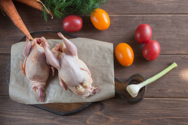 istock Fresh raw organic quail meat on craft paper. 1326968321