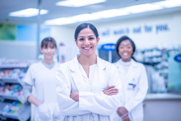 istock Confident Indian female pharmacist with her team 1326968571