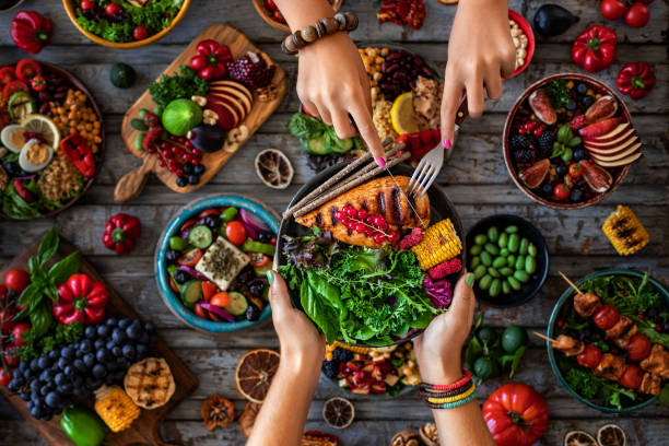 istock Hands of two woman sharing their meal. 1326969404