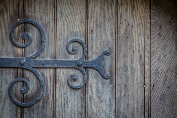 An ornate wrought iron hinge on an old church door