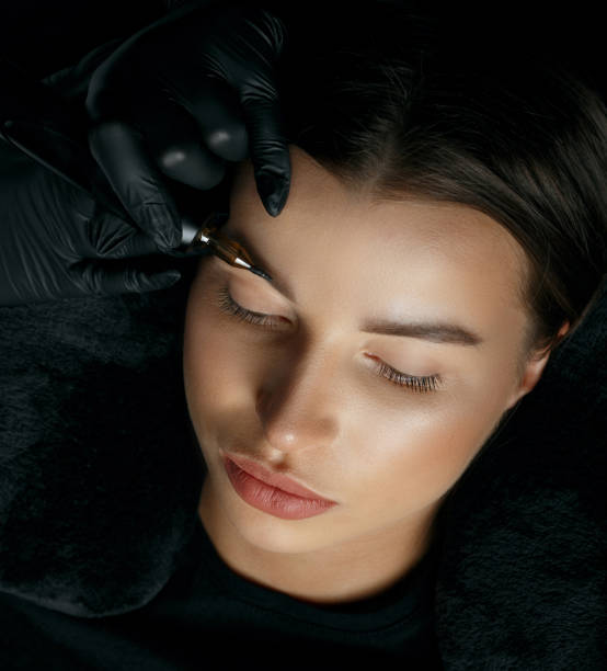 istock Pretty woman having eyebrow permanent procedure 1326973133