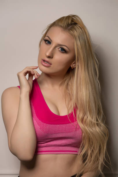 istock Adorable athletic model with perfect makeup and curly hair posing on a white background 1326973201