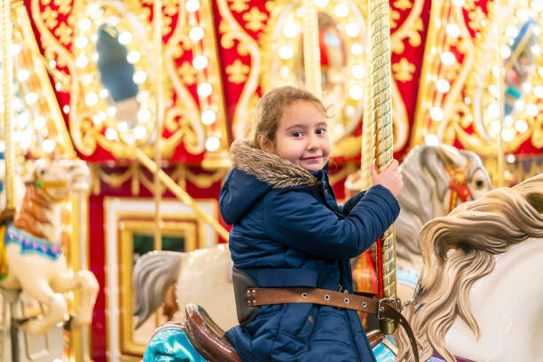 istock Little girl on carousel 1326974246