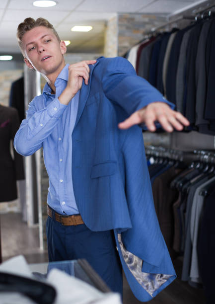 istock Portrait of man costumer trying jacket 1326974584