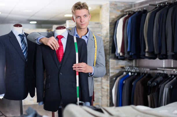 istock Seller in business clothes measuring jacket 1326974589