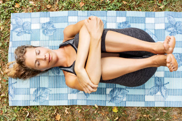 istock Young woman practicing yoga eyes closed contemplating 1326977158
