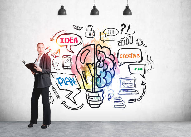 istock Businesswoman with notebook in hands, light bulb on a concrete wall 1326977775