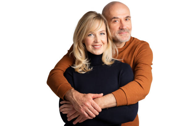 istock Happy couple standing at isolated white background 1326978274