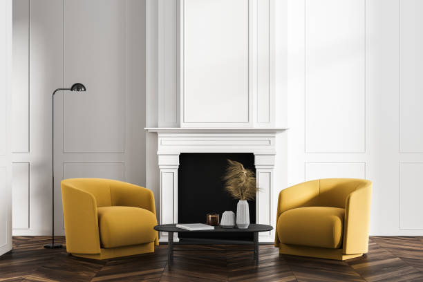 istock Minimalistic white living room interior with two yellow armchairs, fireplace and coffee table 1326979178