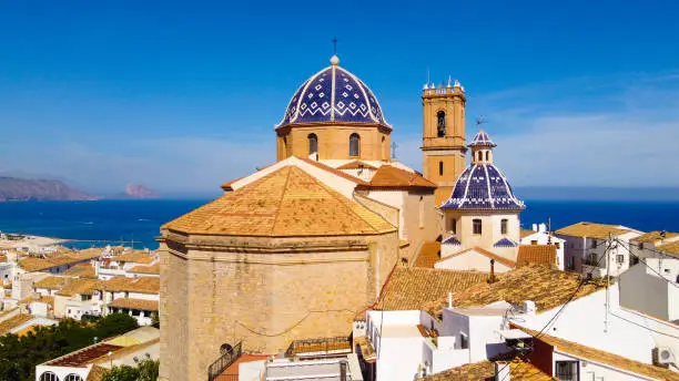 Aerial view of the Church of Altea Nuestra Señora del Consuelo roofs of the houses of the old town and view of the sea as a background