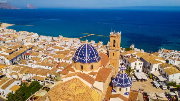 Aerial view of the Church of Altea Nuestra Señora del Consuelo roofs of the houses of the old town and view of the sea as a background