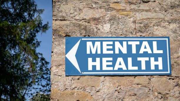 Mental Health concept. Blue directional sign on a dolomite masonry wall