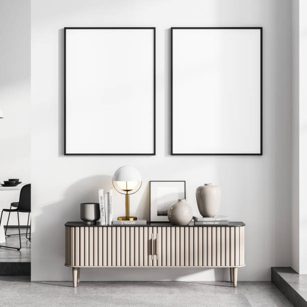 istock Minimalist style white living room interior with bookshelf and two vertical posters 1326980513