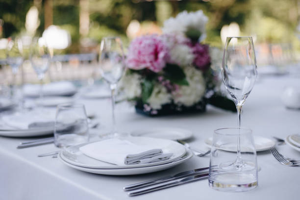 istock tableware Glasses, flower fork, knife served for dinner in restaurant with cozy interior 1326981691