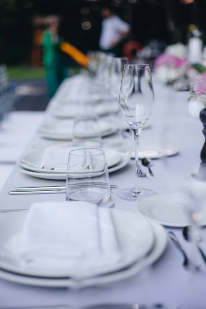 istock tableware Glasses, flower fork, knife served for dinner in restaurant with cozy interior 1326981902
