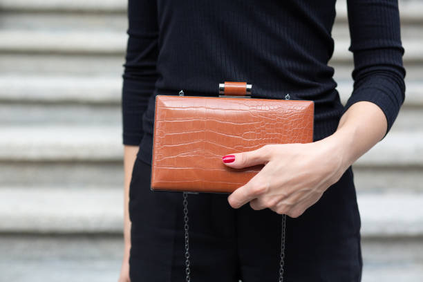 istock Female hand holding small purse 1326982719