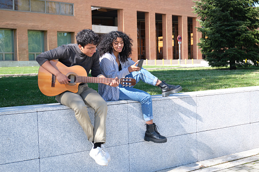 Mixed race girl having fun with guitar