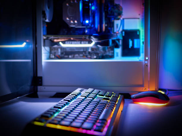 istock Desktop gaming PC and backlit keyboard. Components of the computer. PC case with RGB light 1326989244