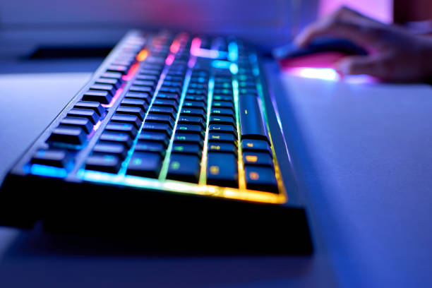 istock Backlit keyboard and mouse in the background. Gaming concept. Gaming led keyboard with multi-colored backlight 1326989272