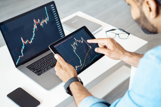 istock Close-up of tablet computer with graphs, diagrams and charts on screen in hands 1326989373