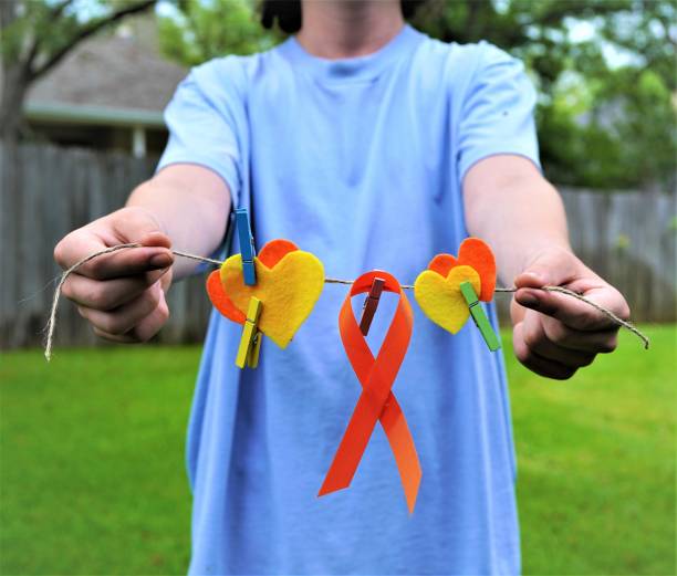 istock Orange Ribbon, Hearts, Hands--Medican Awareness: leukemia; multiple sclerosis 1326990069