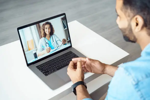 Photo of View over client shoulder sit at desk receive medical consultation online