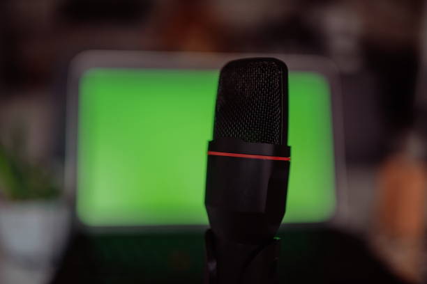 istock Home studio podcast interior. Microphone, laptop and on air lamp on the table, close-up. 1326992748