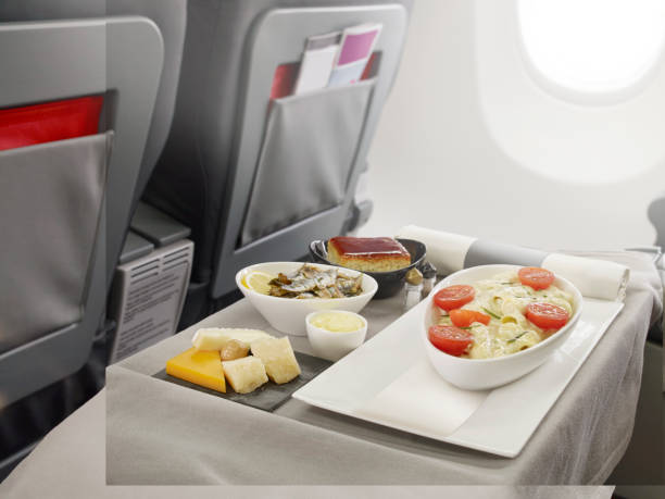 Business class food on board Serving fish dish as a business class food on board airplane food stock pictures, royalty-free photos & images