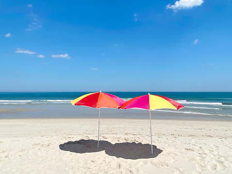 Empty beach with beach umbrellas