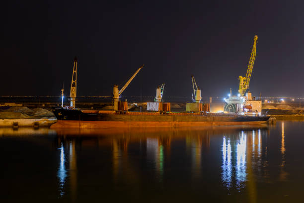 istock Bulk carrier vessel moored alongside berth in port. Night view. Bulker. Dry cargo ship. 1326998402