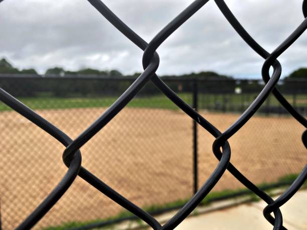 istock ChainLink Fence at an Overcast Ball field 1327001614